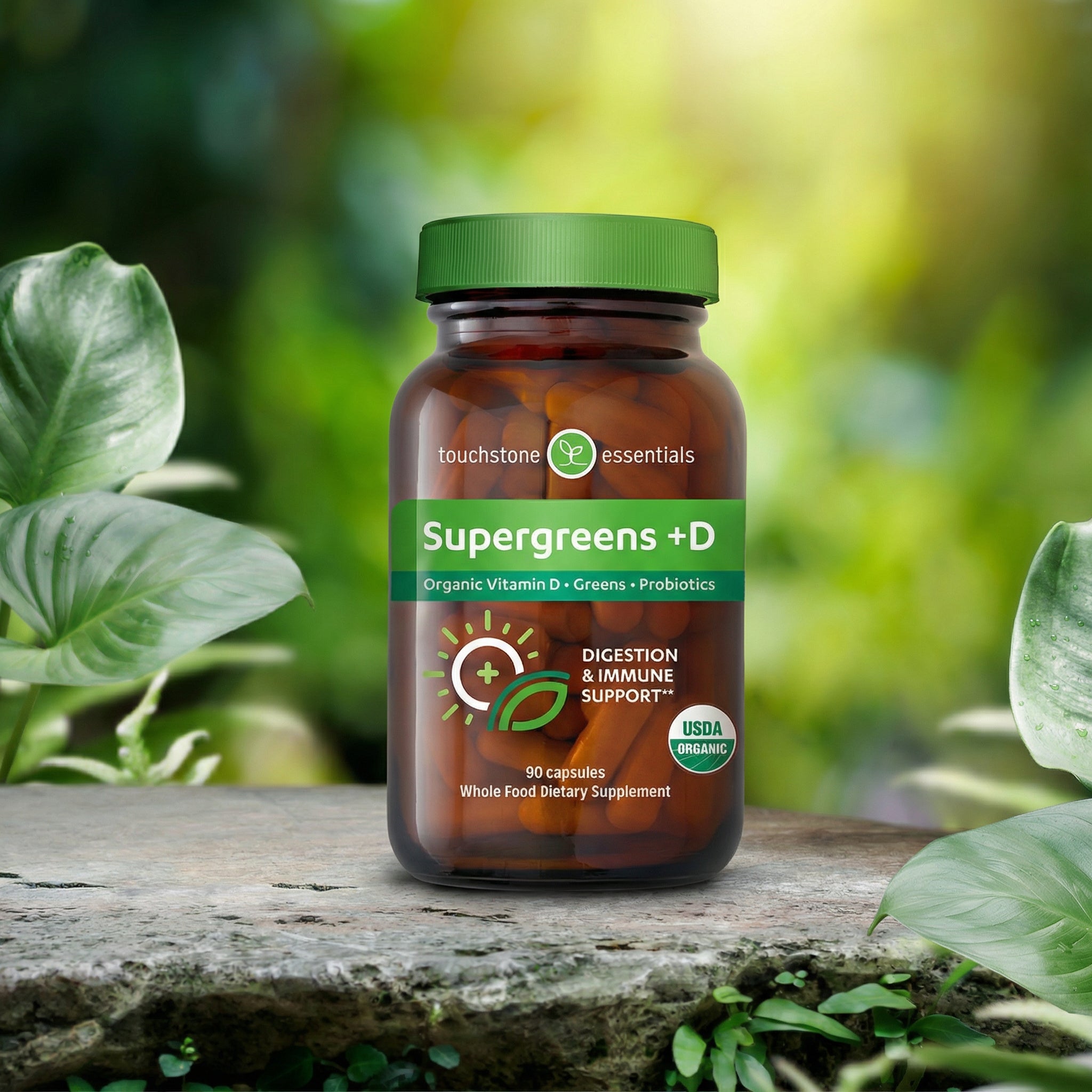 Supergreens +D supplement bottle on a wooden surface with greenery in the background