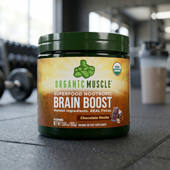 Container of Organic Muscle Brain Boost supplement in a gym setting