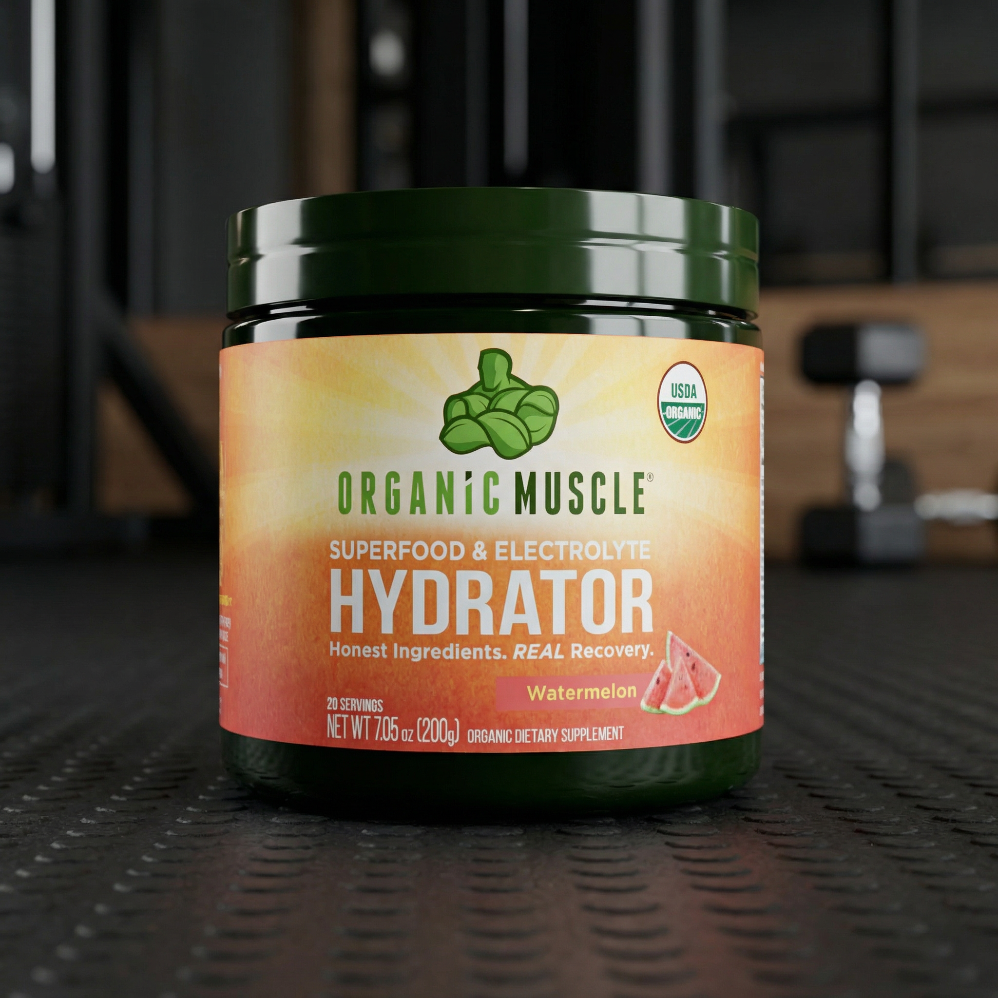 Container of Organic Muscle Hydrator on a dark surface with gym equipment in the background